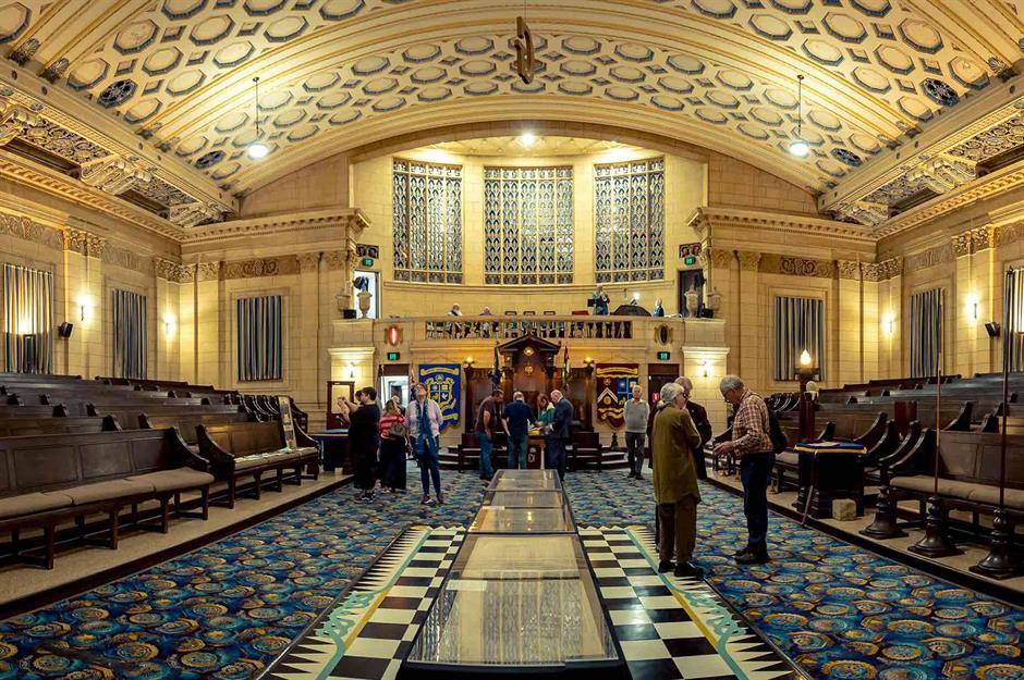 The main lodge room of the Brisbane Masonic Centre, Queensland, with ornate plasterwork and stained glass